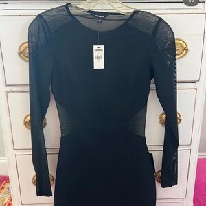 Black see through Express dress. Has open back, arms, and side.